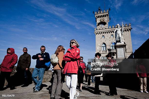 Tourists stroll past the Palazzo Publico, or town hall, of the Republic of San Marino, in San Marino, on Monday, April 19, 2010. San Marino, which is...