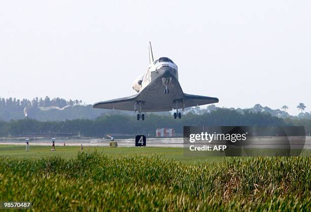 The US space shuttle Discovery glides in for landing April 20, 2010 at Kennedy Space Center's runway 33 in Florida completing fifteen days in space....
