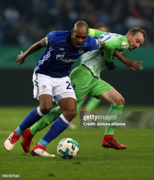 Schalke's Naldo and Wolfsburg's Maximilian Arnold battle for the ball during the German DFB Cup quarterfinal match between FC Schalke 04 and VfL...