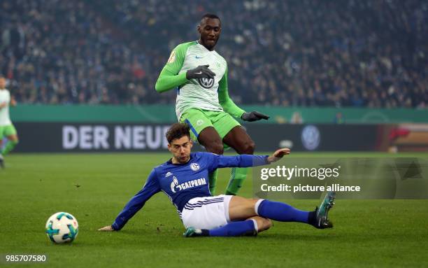 Schalke's Leon Goretzka and Wolfsburg's Marcel Tisserand vie for the ball during the German DFB Cup quarter-final match between FC Schalke 04 and VfL...