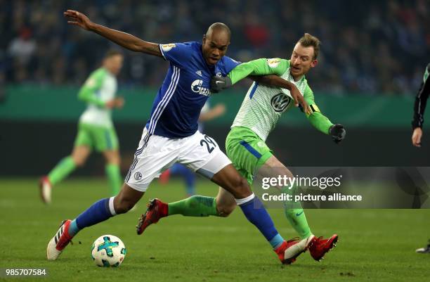 Schalke's Naldo and Wolfsburg's Maximilian Arnold vie for the ball during the German DFB Cup quarterfinal match between FC Schalke 04 and VfL...