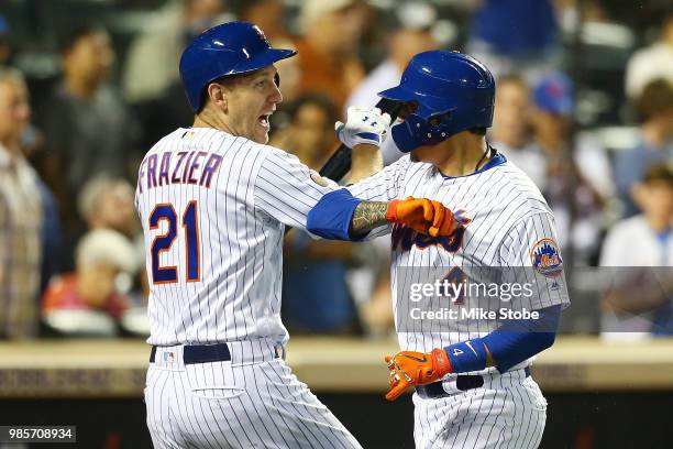 Wilmer Flores of the New York Mets celebrates with Todd Frazier after hitting a solo home run in the sixth inning against the Pittsburgh Pirates at...