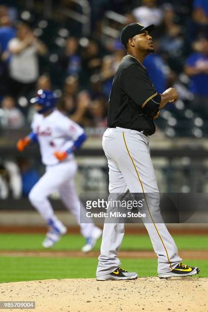 Wilmer Flores of the New York Mets rounds third base after hitting a solo home run in the sixth inning as Ivan Nova of the Pittsburgh Pirates look on...
