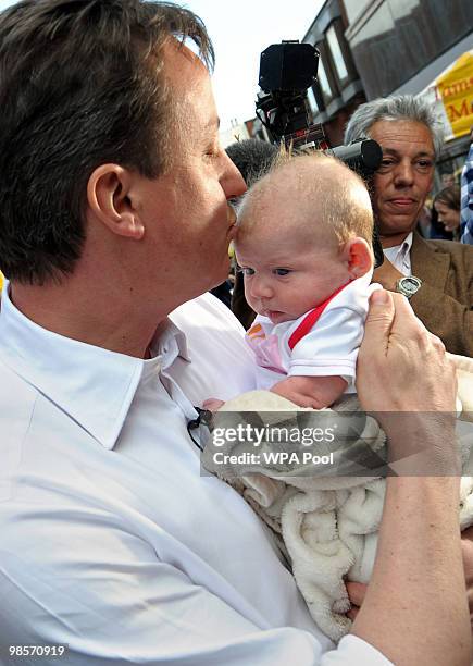 British opposition Conservative party leader, David Cameron, kisses a baby while campaigning in Tamworth, central England on April 20, 2010. The...