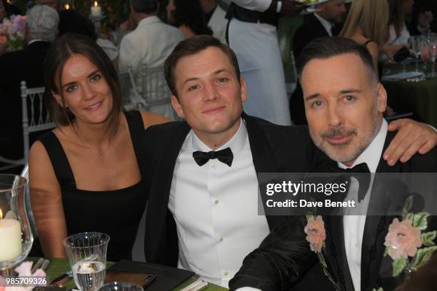 Emily Thomas, Taron Egerton and David Furnish attend the Argento Ball for the Elton John AIDS Foundation in association with BVLGARI & Bob and Tamar...