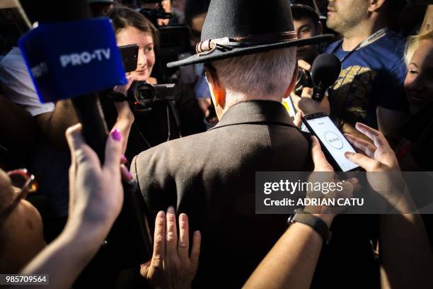 Romanian philosopher Mihai Sora is surrounded by reporters while taking part in a protest in front of the prime minister's office in Bucharest,...