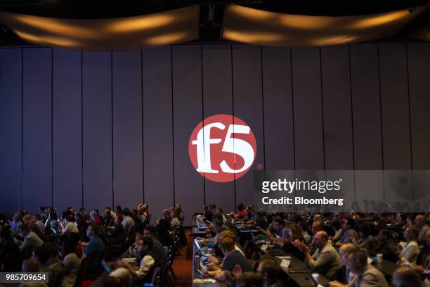 Attendees listen as a F5 Networks Inc. Logo is projected on a wall during the GeekWire Cloud Tech Summit in Bellevue, Washington, U.S., on Wednesday,...