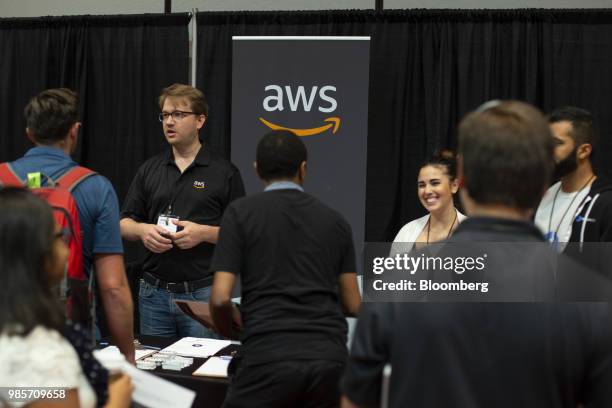 Attendees visit the Amazon.com Inc. Web Services booth during the GeekWire Cloud Tech Summit in Bellevue, Washington, U.S., on Wednesday, June 27,...