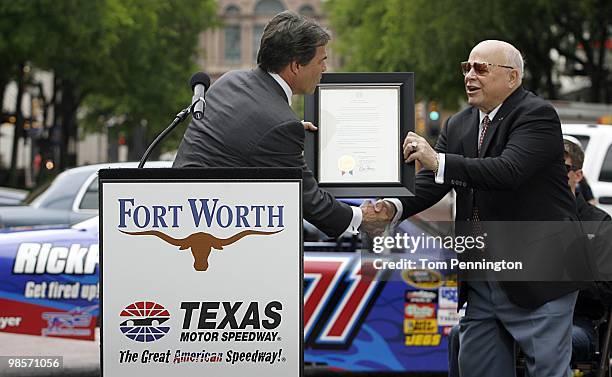 Texas Governor Rick Perry presents Speedway Motorsports, Inc. Chairman Bruton Smith with a Texas state proclamation on April 15, 2010 in Fort Worth,...