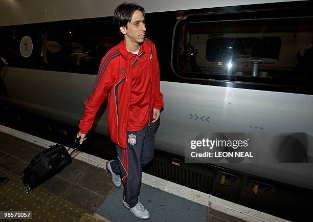 Liverpool's Israeli midfielder Yossi Benayoun walks along the platform after arriving by train at Euston station in central London, on April 20,...