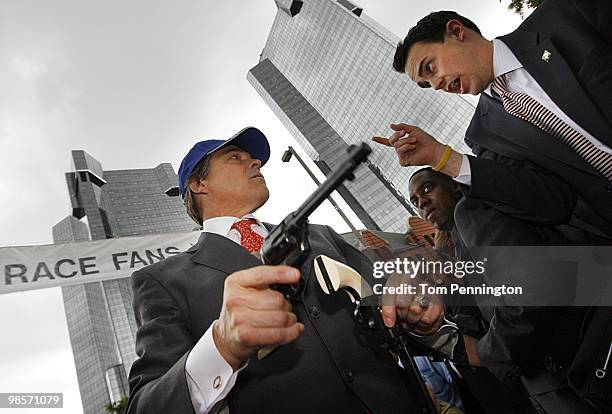 Texas Governor Rick Perry carries two six-shooter revolvers during an event with Texas Motor Speedway on April 15, 2010 in Fort Worth, Texas.