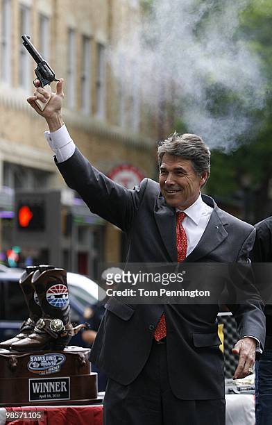 Texas Governor Rick Perry fires a six-shooter pistol in downtown Fort Worth during a promotional event with Texas Motor Speedway on April 15, 2010 in...