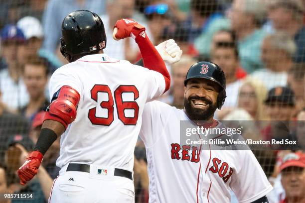 Eduardo Nunez of the Boston Red Sox reacts with Sandy Leon after hitting a solo home run during the second inning of a game against the Los Angeles...