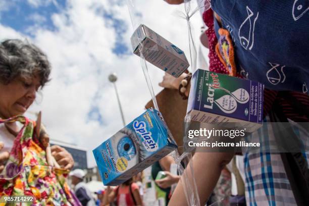 People protest because of the lack of medicine in Caracas, Venezuela, 8 February 2018. Medicine packages hang from a protester's self made banner....