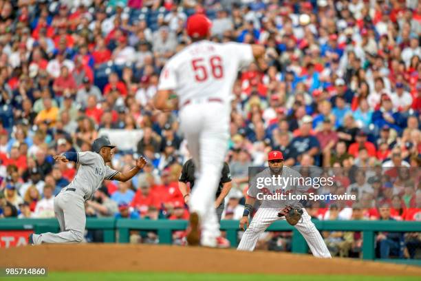 Philadelphia Phillies first baseman Carlos Santana waits for the throw from Philadelphia Phillies starting pitcher Zach Eflin as New York Yankees...