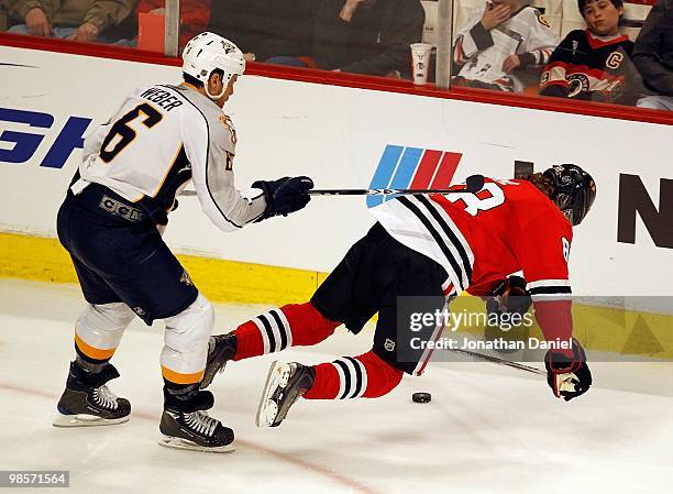 Patrick Kane of the Chicago Blackhawks is knocked down from behind by Shea Weber of the Nashville Predators in Game Two of the Western Conference...