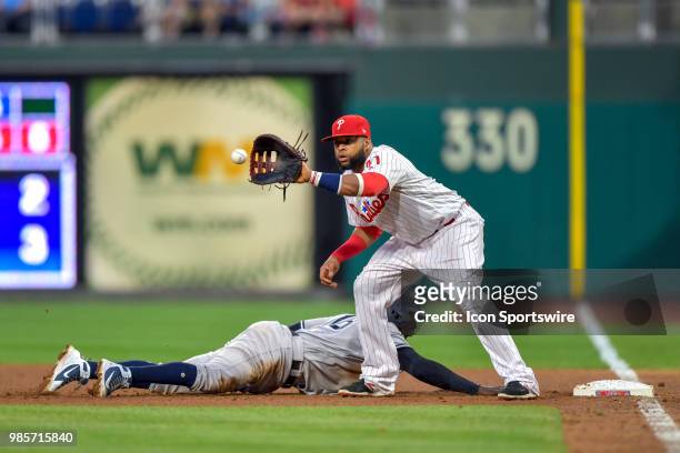 Philadelphia Phillies first baseman Carlos Santana snares the ball too late to make the play during the MLB game between the New York Yankees and the...