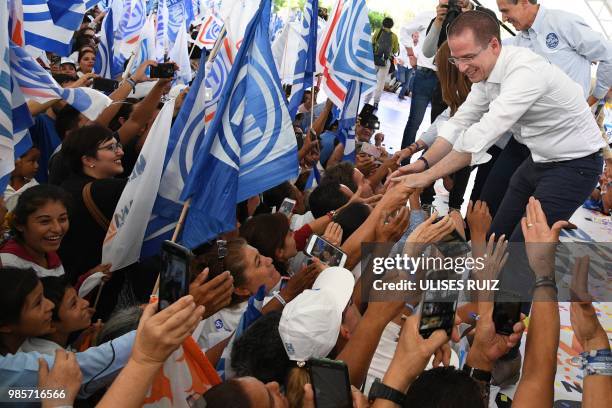 Mexico's presidential candidate Ricardo Anaya, standing for the "Mexico al Frente" coalition of the PAN-PRD-Movimiento Ciudadano parties, greets...