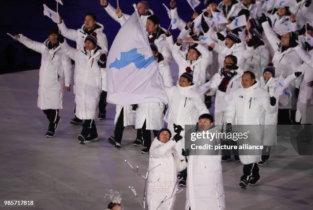 The joint team of South and North Korea walks into the stadium at the opening ceremony of the Winter Olympics in Pyeongchang, South Korea, 9 February...