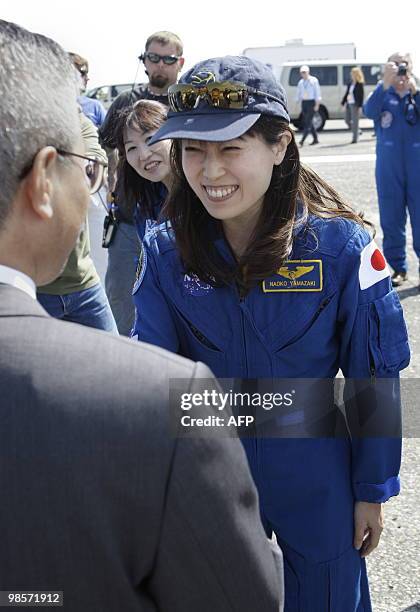 Mission specialist Naoko Yamazaki of the Japan Aerospace Exploration Agency is greeted by Dr. Kuniaki Shiraki , executive director of JAXA, after the...