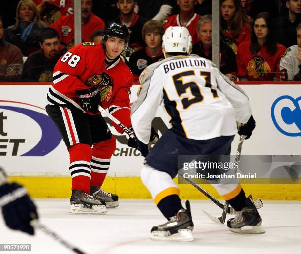 Patrick Kane of the Chicago Blackhawks looks to pass around Francis Bouillon of the Nashville Predators in Game Two of the Western Conference...