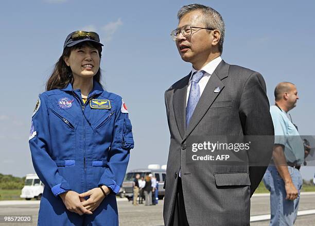 Mission specialist Naoko Yamazaki of the Japan Aerospace Exploration Agency talks with Dr. Kuniaki Shiraki , executive director of JAXA, after the...