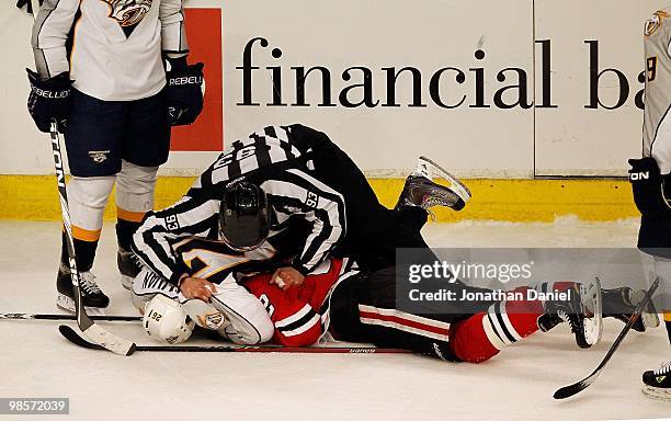 Referee tries to pull Steve Sullivan of the Nashville Predators off of Kris Versteeg of the Chicago Blackhawks in Game Two of the Western Conference...