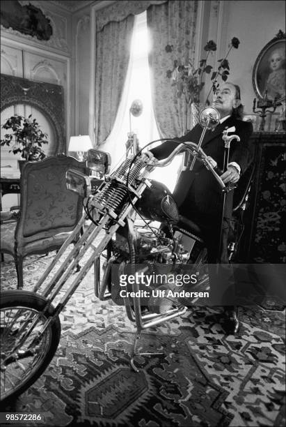 Spanish artist Salvador Dali poses on a Harley Davidson motorbike at the Le Meurice Hotel on October 24,1973 in Paris,France.