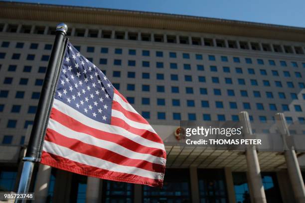 The US flag flutters on a diplomatic car after a meeting of US Defence Secretary Jim Mattis with China's Vice Chairman of the Central Military...