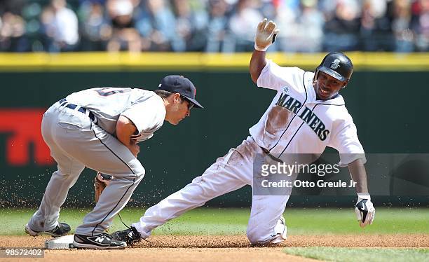 Chone Figgins of the Seattle Mariners is tagged out on a steal attempt at second base by Scott Sizemore of the Detroit Tigers at Safeco Field on...