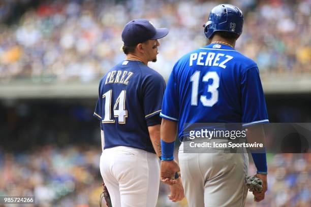 Milwaukee Brewers left fielder Hernan Perez and Kansas City Royals catcher Salvador Perez chat between pitches during a game between the Milwaukee...