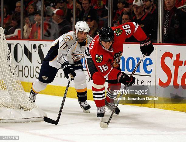 Dave Bolland of the Chicago Blackhawks controls the puck in front of David Legwand of the Nashville Predators in Game Two of the Western Conference...