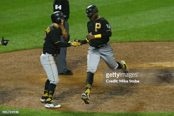Gregory Polanco and Corey Dickerson of the Pittsburgh Pirates celebrate after scoring on David Freese single in the ninth inning against the New York...