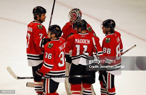 Brent Seabrook, Dave Bolland, John Madden and Patrick Kane of the Chicago Blackhawks congratulate teammate Antti Niemi after a shut-out win over the...