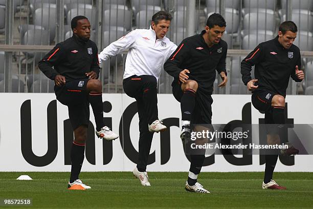 Sidney Govou of Olympic Lyon runs with Claude Puel head coach of Lyon, Cleber Anderson and Anthony R?veill?re during a training session at Allianz...