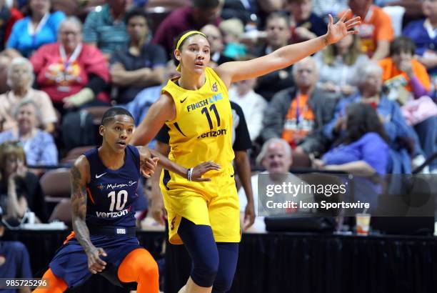 Indiana Fever forward Natalie Achonwa calls for the ball while defended by Connecticut Sun guard Courtney Williams during a WNBA game between Indiana...