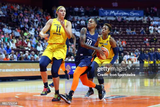 Connecticut Sun guard Courtney Williams drives to the basket pursued by Indiana Fever forward Natalie Achonwa and Indiana Fever guard Tiffany...