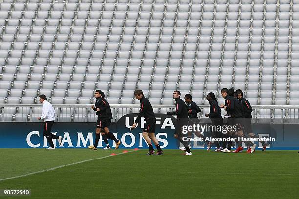 Claude Puel , head coach of Olympic Lyon runs with his players during a training session at Allianz Arena on April 20, 2010 in Munich, Germany....