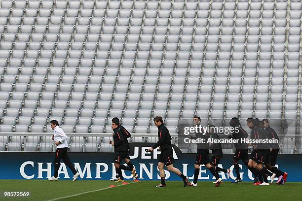 Claude Puel , head coach of Olympic Lyon runs with his palyers during a training session at Allianz Arena on April 20, 2010 in Munich, Germany....