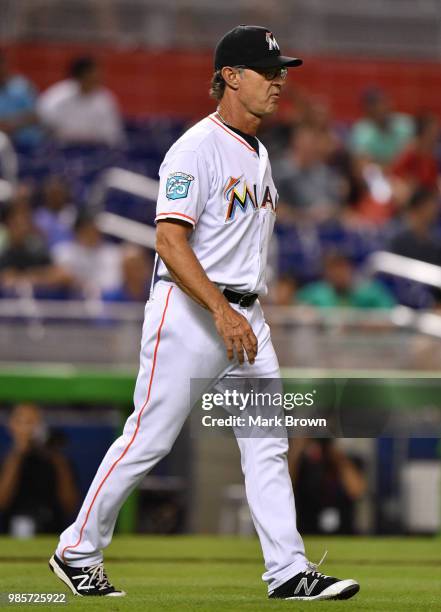 Don Mattingly of the Miami Marlins walks to the mound to make a pitching change in the eighth inning during the game against the Arizona Diamondbacks...