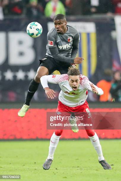 Leipzig's Yussuf Poulsen and Augsburg's Kevin Danso vie for the ball during the German Bundesliga soccer match between RB Leipzig and FC Augsburg in...