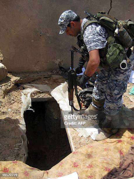 An Iraqi soldier searches the site where allegedly top Al-Qaeda leaders in Iraq, Abu Omar al-Baghdadi and Abu Ayyub al-Masri, were killed in a joint...