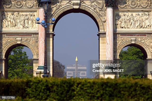 "The Arc de Triomphe" and the obelisk of the Place de la Concorde are show through the arc of the Louvre Carrousel in Paris on April, 16 2010. AFP...