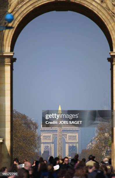 "The Arc de Triomphe" and the obelisk of the Place de la Concorde are show through the arc of the Louvre Carrousel in Paris on April, 16 2010. AFP...