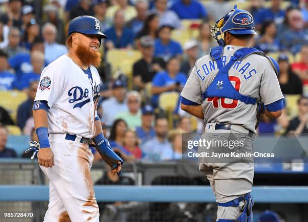 Justin Turner of the Los Angeles Dodgers and Willson Contreras of the Chicago Cubs exchange words after Turner was tagged out at home in the first...