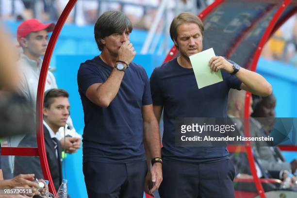 Joachim Loew, head coach of Germany looks on with his aasietnt coach Thomas Schneider during the 2018 FIFA World Cup Russia group F match between...