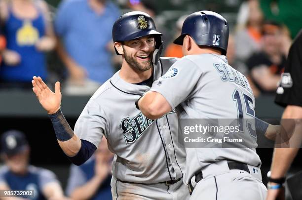 Kyle Seager of the Seattle Mariners celebrates with Mitch Haniger after hitting a two-run home run in the ninth inning against the Baltimore Orioles...