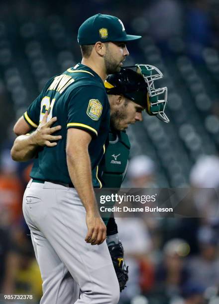 Lou Trivino of the Oakland Athletics celebrates with catcher Josh Phegley of the Oakland Athletics after a 3-0 win over the Detroit Tigers at...