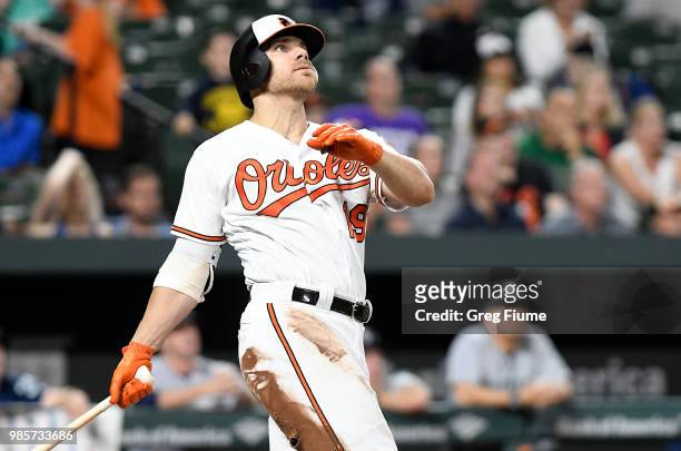Chris Davis of the Baltimore Orioles hits a three-run home run in the eighth inning against the Seattle Mariners at Oriole Park at Camden Yards on...