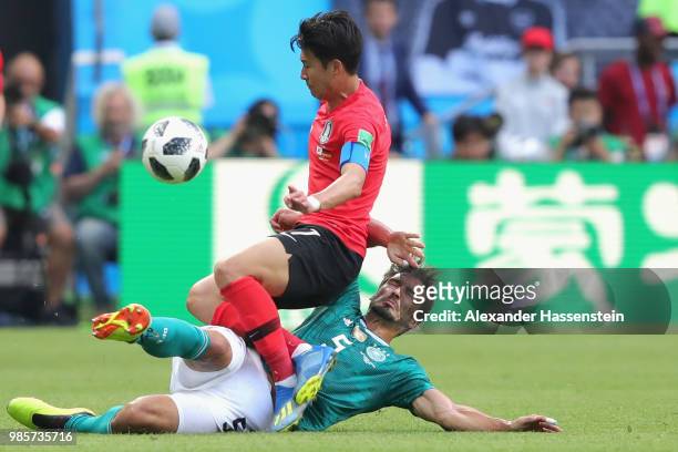 Mats Hummels of Germany tackles Heungmin Son of Korea Republic during the 2018 FIFA World Cup Russia group F match between Korea Republic and Germany...